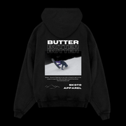 Back of Skoto Butter Board Hoodie – black hoodie with skier buttering graphic, triple “Butter” text design, and Skoto Apparel branding