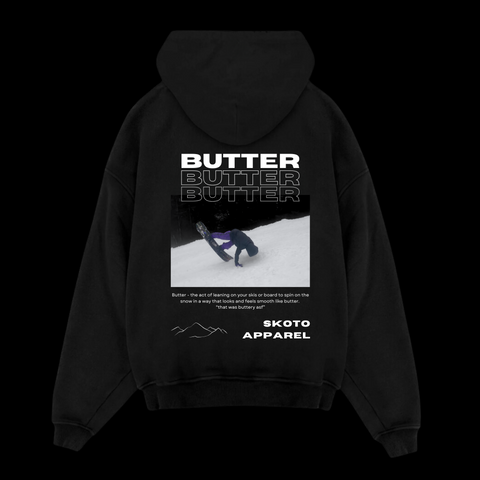 Back of Skoto Butter Board Hoodie – black hoodie with skier buttering graphic, triple “Butter” text design, and Skoto Apparel branding