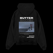 Back of Skoto Butter SKI Hoodie – black hoodie featuring skier buttering graphic, triple “Butter” text, and Skoto Apparel branding