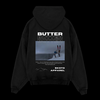 Back of Skoto Butter SKI Hoodie – black hoodie featuring skier buttering graphic, triple “Butter” text, and Skoto Apparel branding