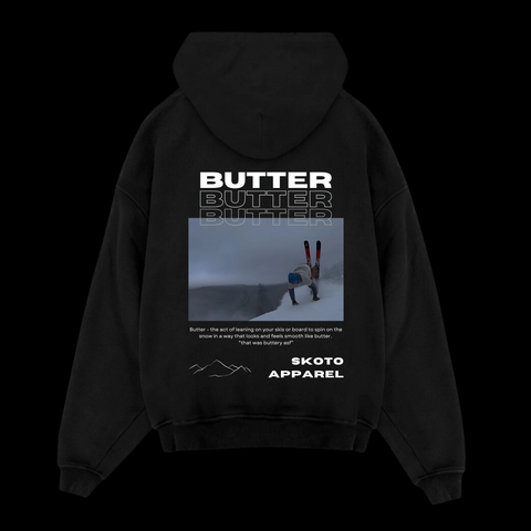 Back of Skoto Butter SKI Hoodie – black hoodie featuring skier buttering graphic, triple “Butter” text, and Skoto Apparel branding