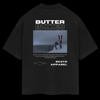 Back of Skoto Butter SKI Tee – black t-shirt featuring skier buttering graphic, triple “Butter” text, and Skoto Apparel branding