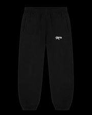 Skoto Short Fit Pants – black tapered sweatpants with white graffiti logo, elastic cuffs, and relaxed streetwear fit